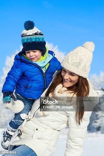 Portrait Of Baby Boy And Mother In Winter Day Stock Photo - Download Image Now - 2015, Adult, Cheerful