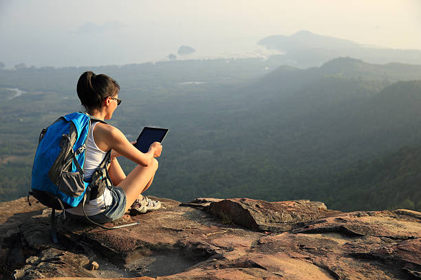 istock hiking woman use digital tablet on mountain peak 537678709