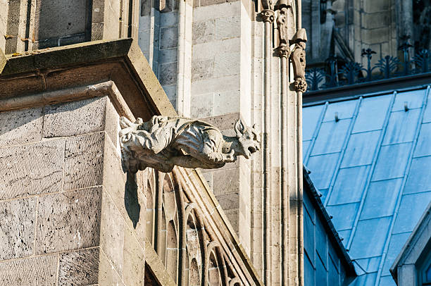 Gargoyl at top of the cathedral Gargoyl at top of the Cologne Cathedral (German: Kolner Dom) of the High Cathedral of Saints Peter and Mary gargoyl stock pictures, royalty-free photos & images