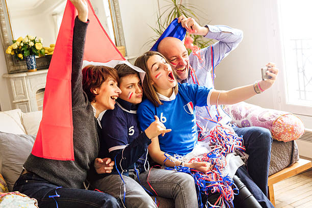 istock french family posing for fan selfie 537686424