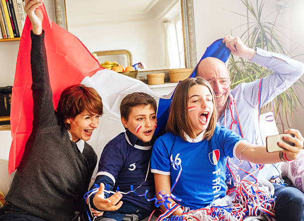 istock french family posing for fan selfie 537686494
