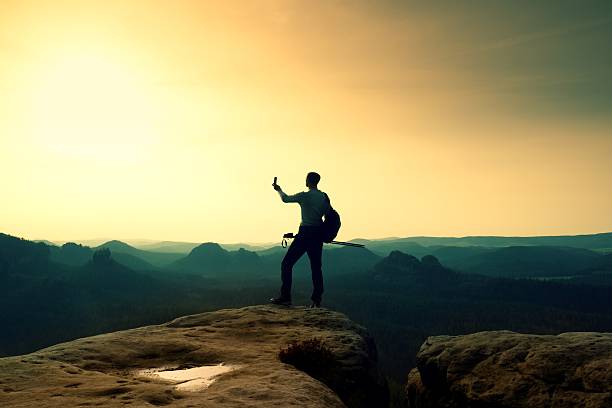 istock Strong hiker taking photo with smartphone. Marvelous mountains daybreak. 537686606