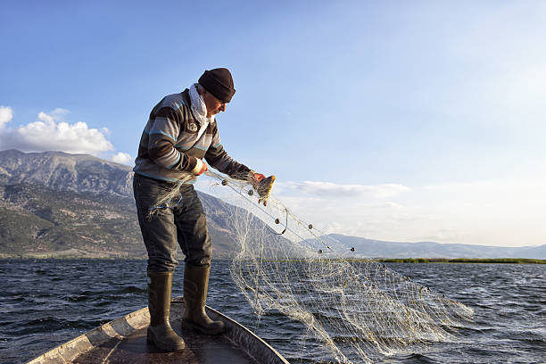 anziano pescatore sulla sua barca - turkish culture turkey fishing boat fishing foto e immagini stock