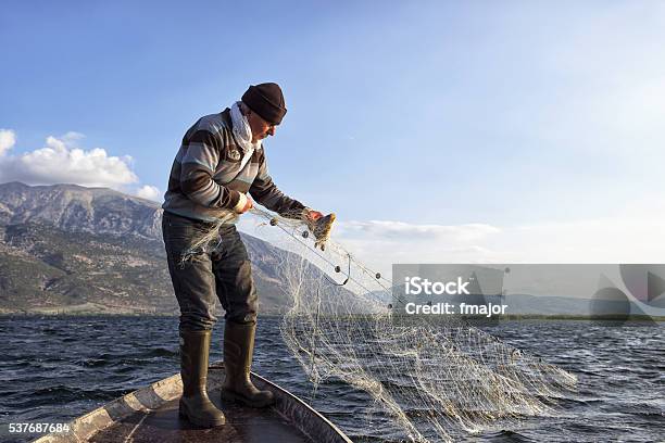 Old Fisherman On His Boat Stock Photo - Download Image Now - Fisher - Role, Fishing, Commercial Fishing Net