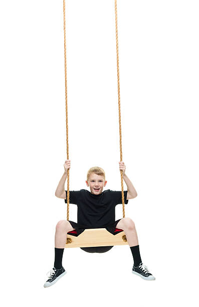 istock Smiling little boy swinging 537688446