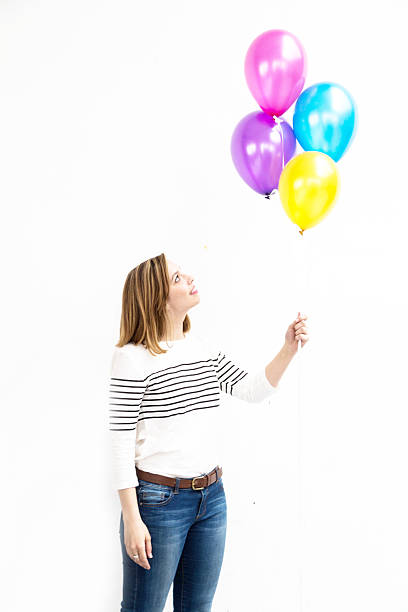 istock Pretty young woman holding balloons 537690252