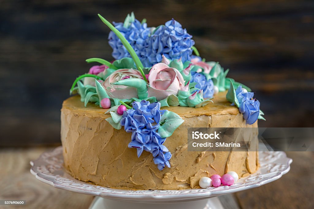 Coffee cake with flowers. Coffee cake with flowers on a white plate. Anniversary Stock Photo