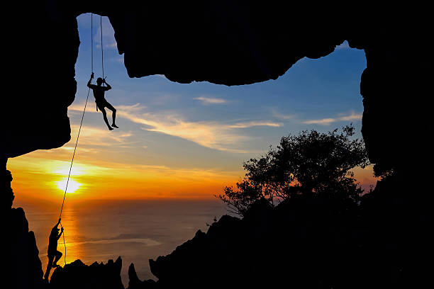 istock Man climbing in the cave on the mountain 537691412