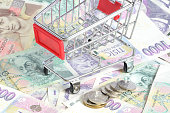 Shopping cart and czech banknotes, coins texture background