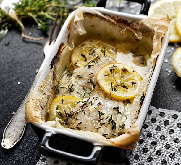 Baked cod fillet with lemon and thyme in a casserole dish
