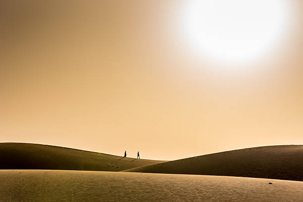 Couple walking together in desert with sunset Couple walking together in desert on a sand dune with sunset hot vietnamese women pictures stock pictures, royalty-free photos & images