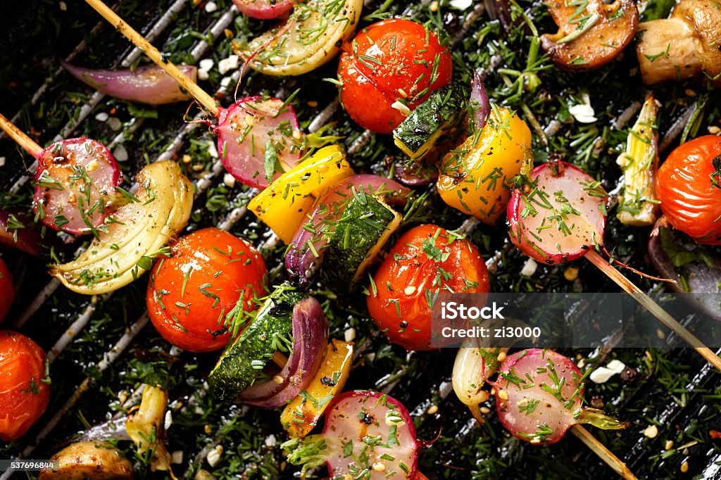 Delicious and healthy vegan skewers Grilled veggie skewers with cherry tomatoes, radishes, peppers and onions with fresh dill on a grill pan Barbecue Grill Stock Photo