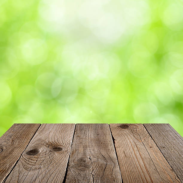 istock Wooden table with green bokeh 537697597