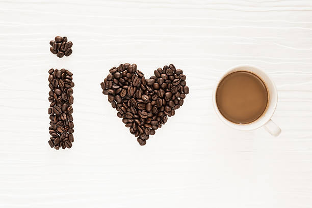 istock I love coffee, coffee beans and mug on wood background. 537698220