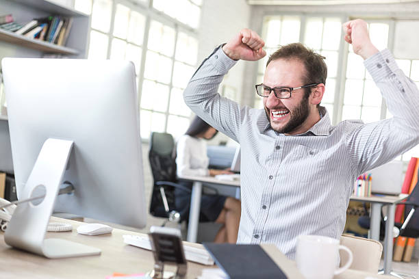 istock Happy young man at the office 537698648