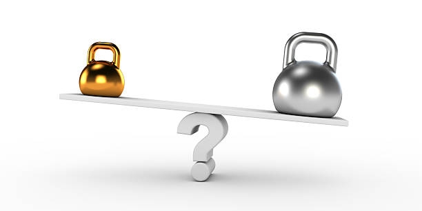 Two gold and silver kettlebells  in equilibrium stock photo