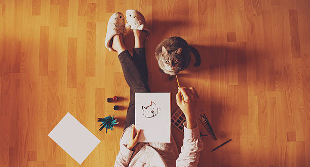 Creative studio: girl drawing her cat.