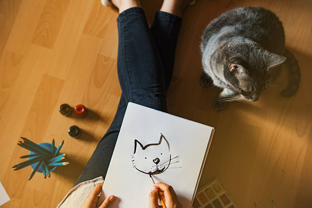 istock Creative studio: girl drawing her cat. 537699530