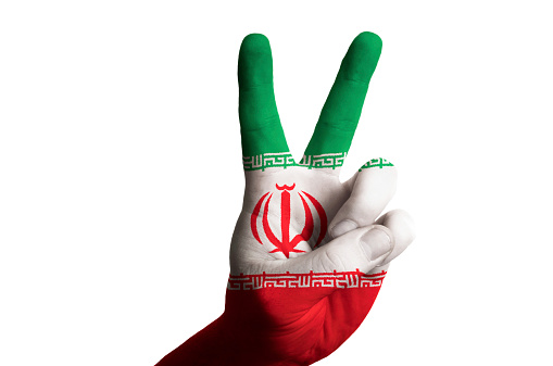 Hand with two finger up gesture in colored iran national flag as symbol of winning, victorious, excellent, - for tourism and touristic advertising, positive political, cultural, social management of country