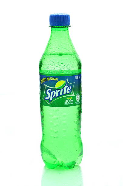 pouring a bottle of cola into a glass, on a white background