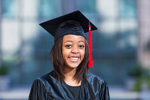 istock Female high school graduate in cap and gown 537701071