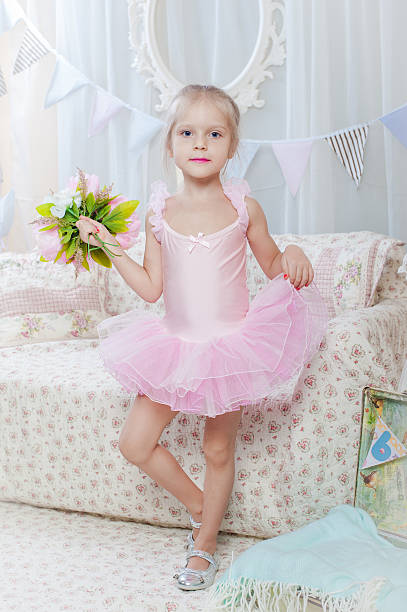 istock Little girl stand with flowers 537702221