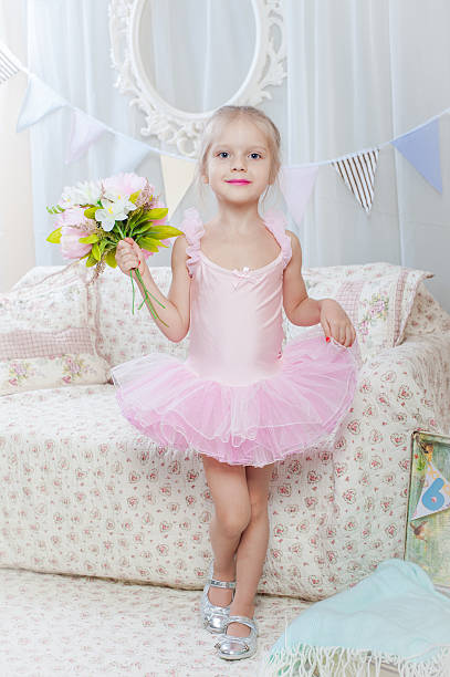istock Little girl stand with flowers 537702225