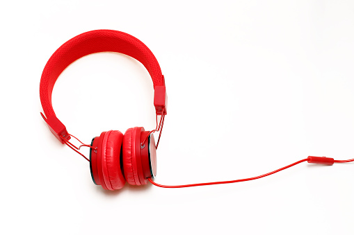 Red headphones isolated on white background.