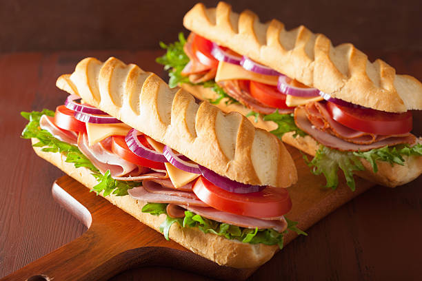 istock long baguette sandwich with ham cheese tomato and lettuce 537703331