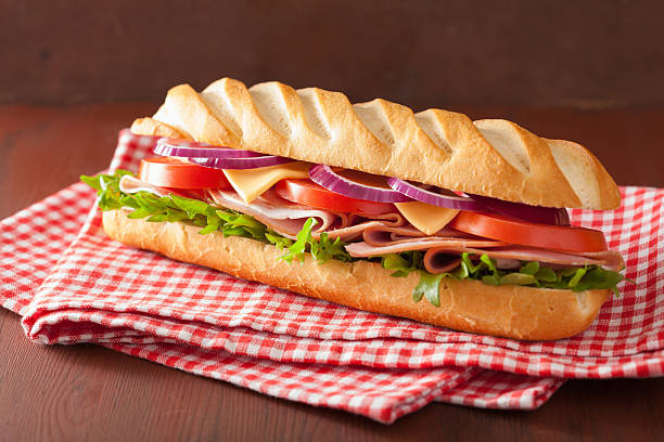 istock long baguette sandwich with ham cheese tomato and lettuce 537703333