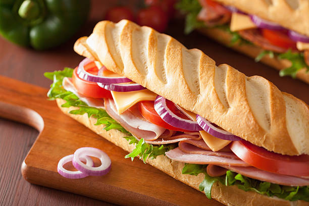 istock long baguette sandwich with ham cheese tomato and lettuce 537703339