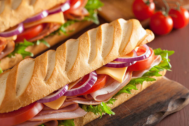 istock long baguette sandwich with ham cheese tomato and lettuce 537703341