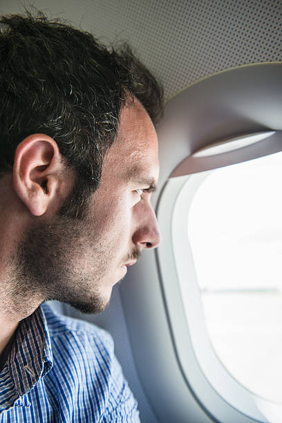 istock Tourist flying and looking out the porthole 537703505