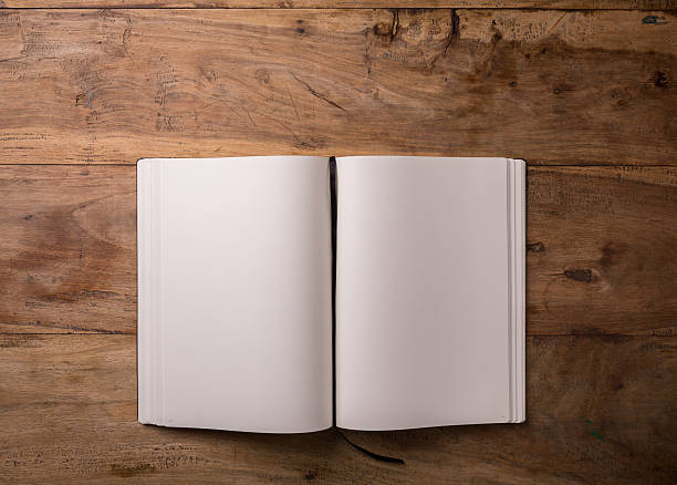 istock Book opened blank on dark wooden background with copy-space, top 537704680