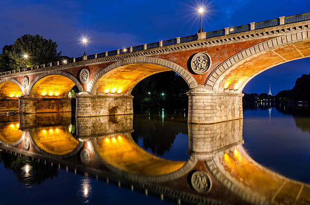 Turin (Torino) Ponte Isabella and river Po at blue hour with Mole Antonelliana in the background