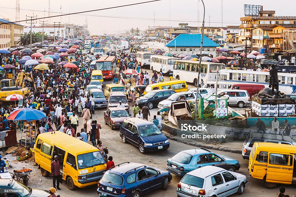 Busy streets of African town. Lagos, Nigeria. Traffic and street market in Ikorodu district just before sunset. Africa Stock Photo