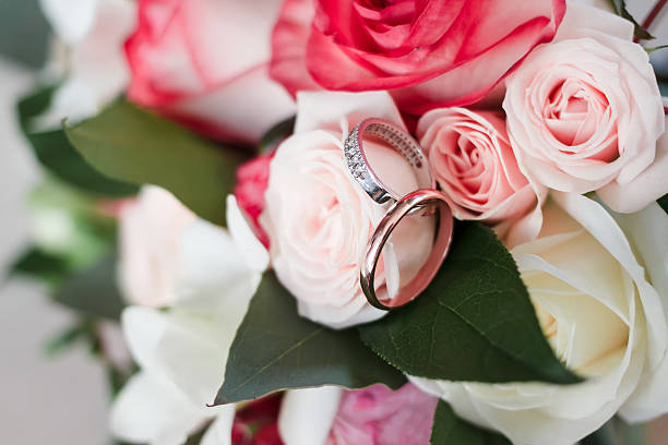 istock wedding rings on a wedding bouquet. 537707346