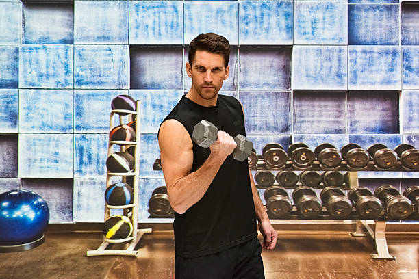 istock Muscular man exercising with dumbbells 537707378