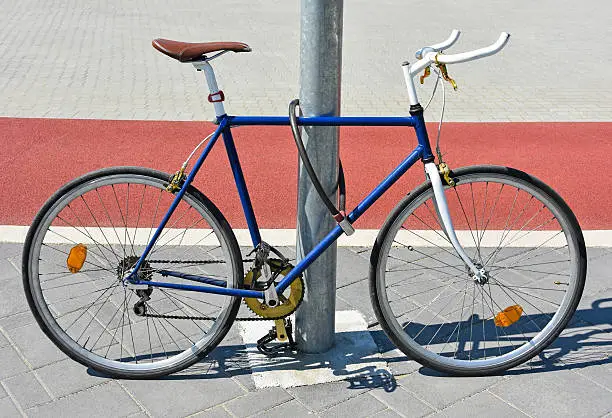 Photo of Bicycle chained to a metal pole
