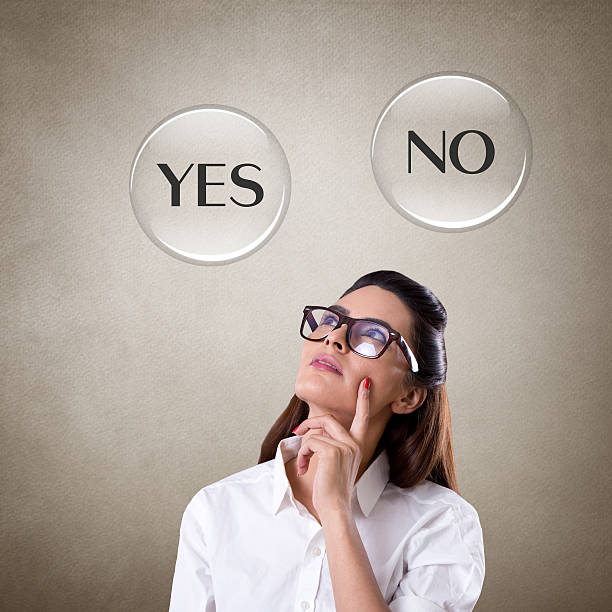 Young businessman looking at text Yes or No. Concept of decisions
