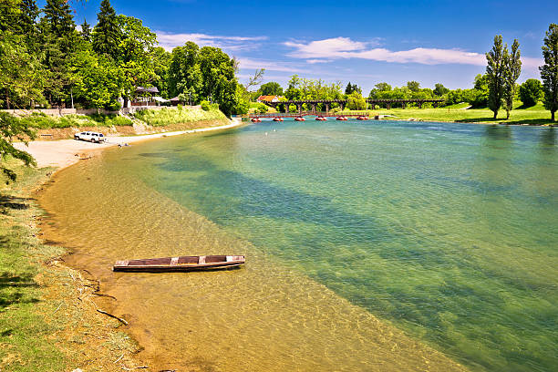 istock Korana river beach and wooden boat 537709322