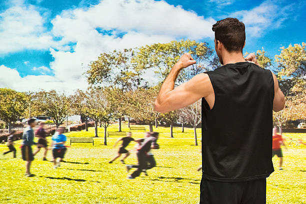 istock Rear view of man cheering in filed 537709522