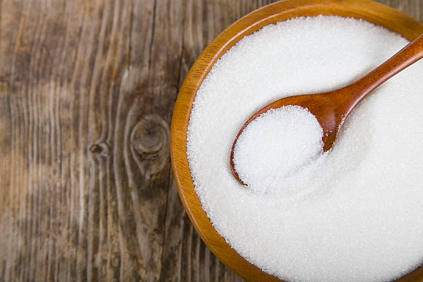 istock Sugar and wooden spoon in a bowl 537709784