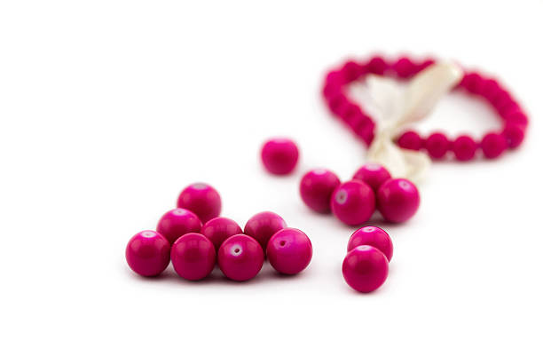 istock Group of pink beads isolated on white background 537713455