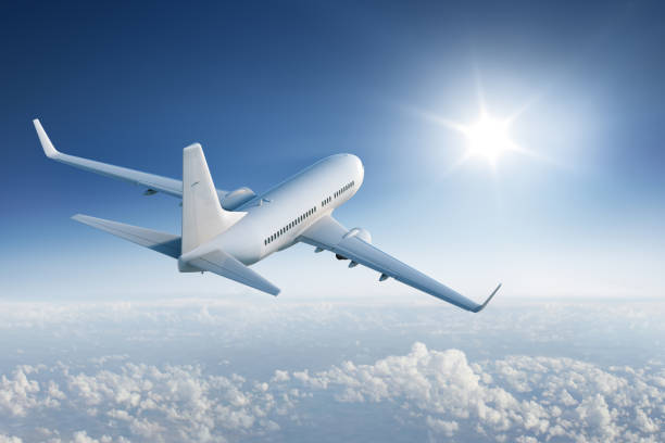 istock Airliner flying towards the sun in blue sky 537713939