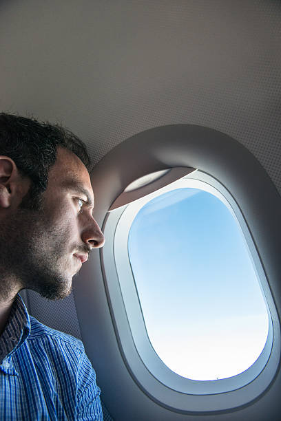istock Tourist flying and looking out the porthole 537714177