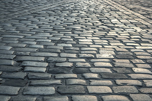 fondo de camino antiguo pavimentado con piedras de granito - artex fotografías e imágenes de stock