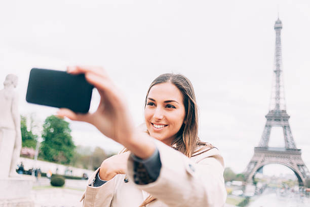 istock Beautiful young woman making selfie in Paris 537714960