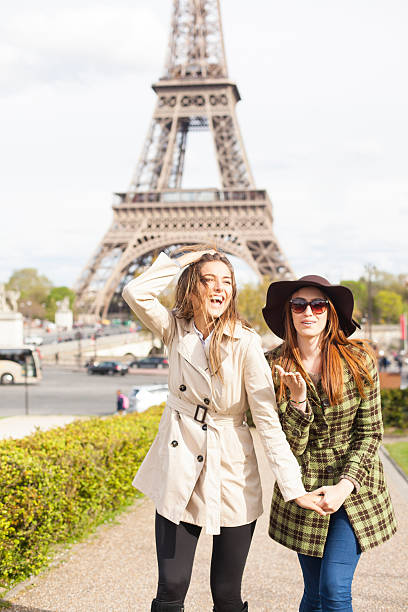 istock Cheerful young women walking in front of Eiffel Tower 537715042
