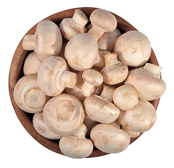 istock Mushrooms in a wooden bowl on a white 537715323